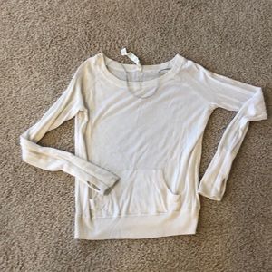 Lululemon white sweater with front pocket.